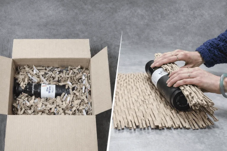 Shredded cardboard used as void fill in a shipping box and expanded cardboard wrap used to protect a bottle