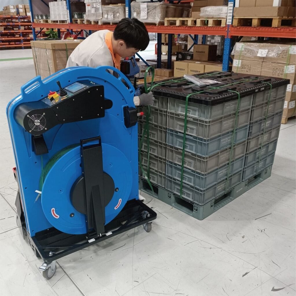Pallet strapping machine positioned beside stacked boxes