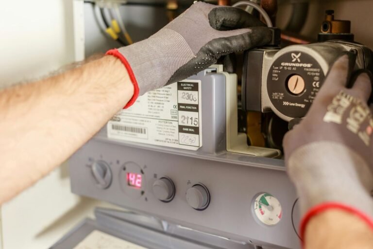 Technician checking internal controls and performing maintenance on a strapping machine