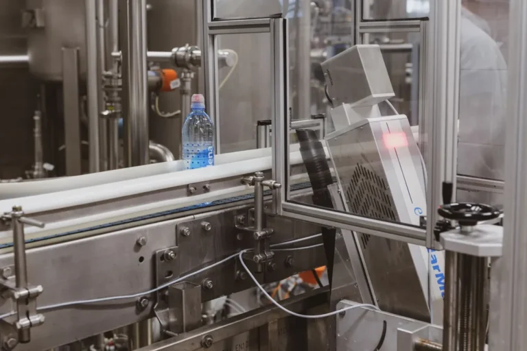 Bouteille en plastique circulant sur une chaîne de production automatisée