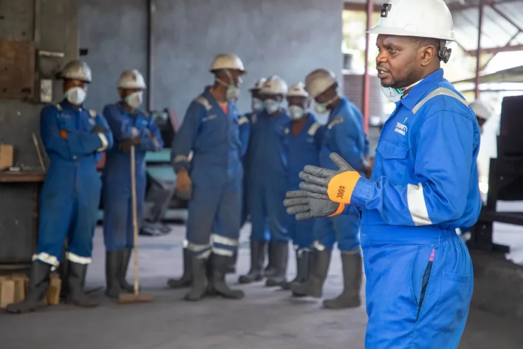 Des ouvriers d'usine reçoivent une formation à la sécurité pour le fonctionnement des machines d'emballage sous film rétractable industriel.