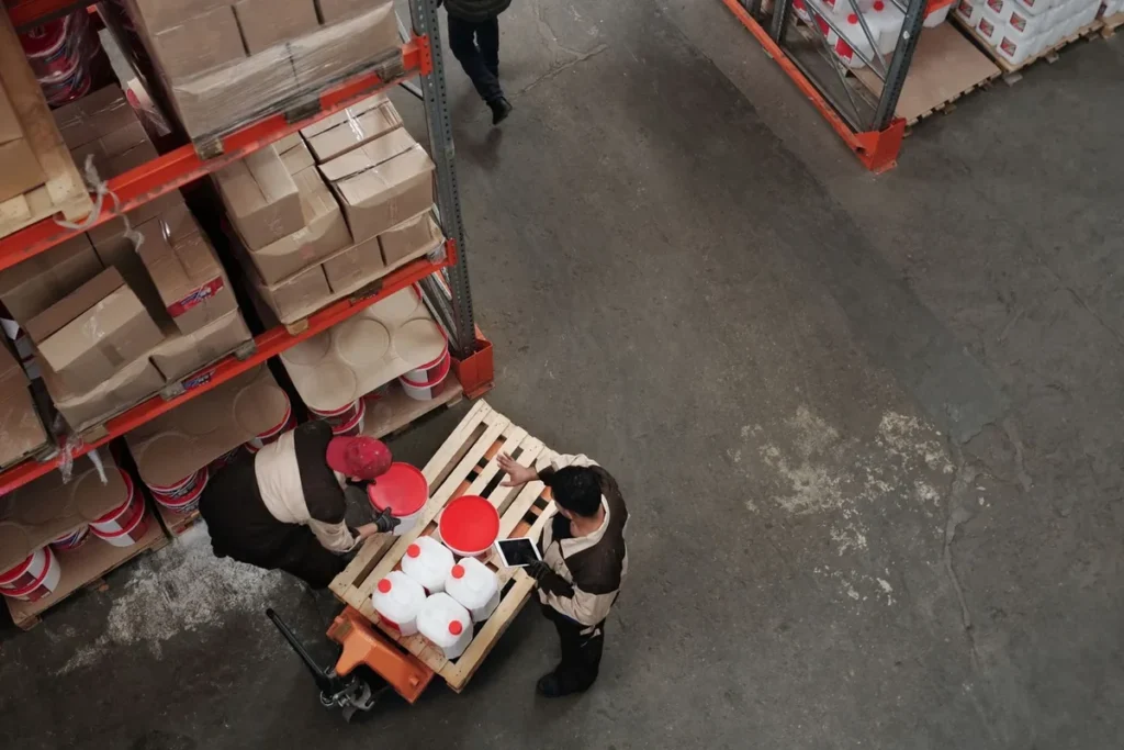 Warehouse team evaluating equipment scope for an industrial shrink wrapping project
