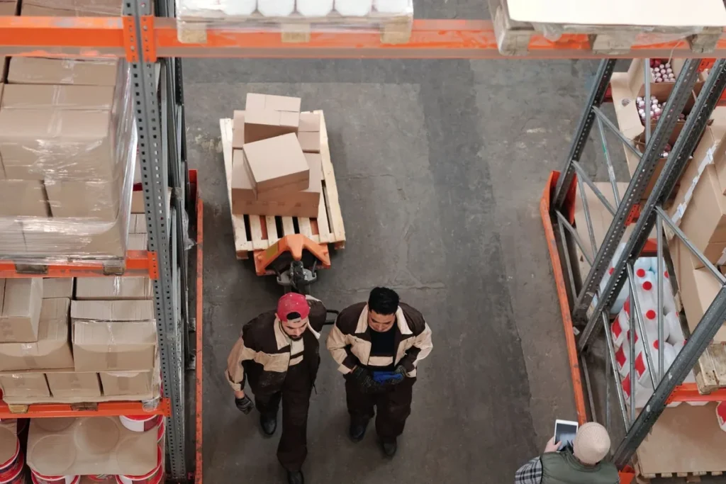 Warehouse team planning equipment requirements for a shrink wrap machine project