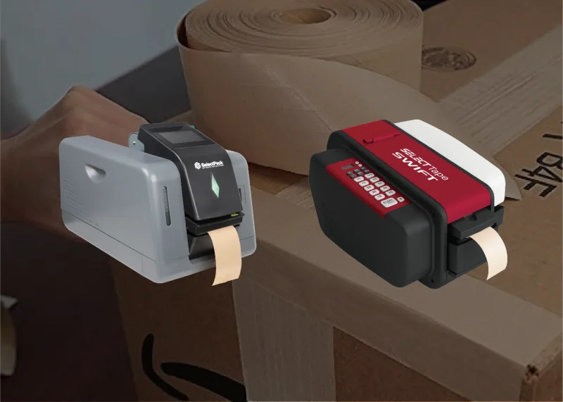Two automatic water-activated tape dispensers sealing cardboard boxes, with kraft tape rolls in the background