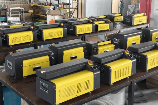 Close-up view of multiple automatic bagging machines lined up on factory tables