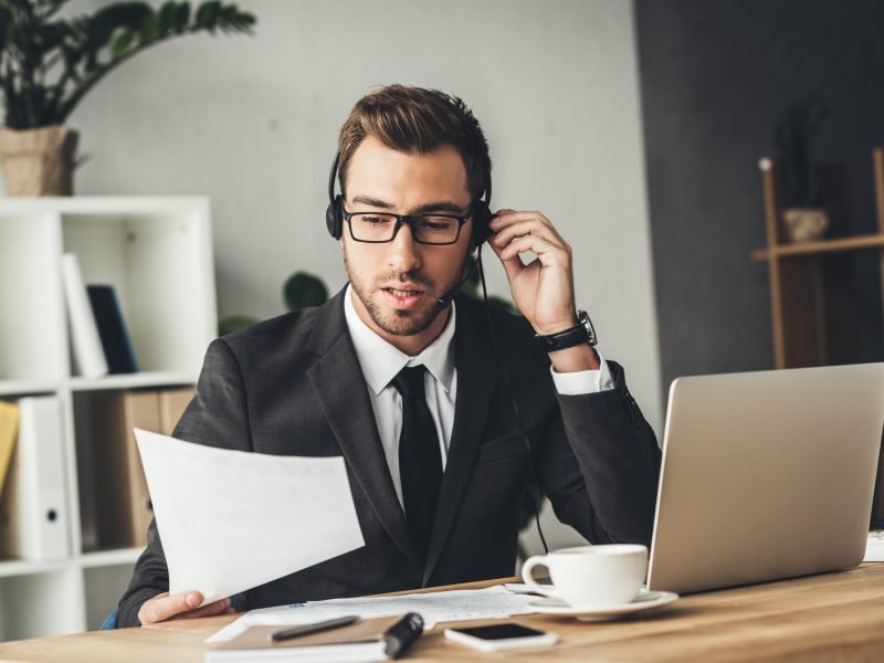 handsome young technical support worker looking at documents handsome young technical support worker looking at documents