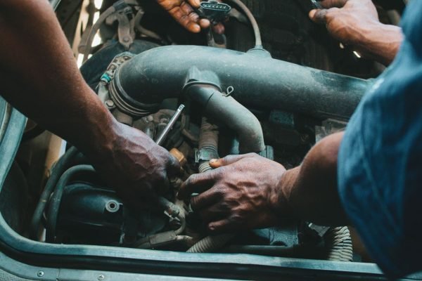 Hands repairing mechanical components of a strapping machine during troubleshooting