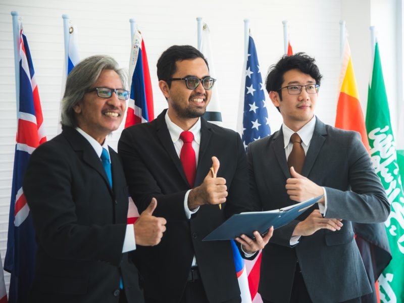 the photo of successful team global business partnership, international flag carriers the photo of successful team global business partnership, international flag carriers